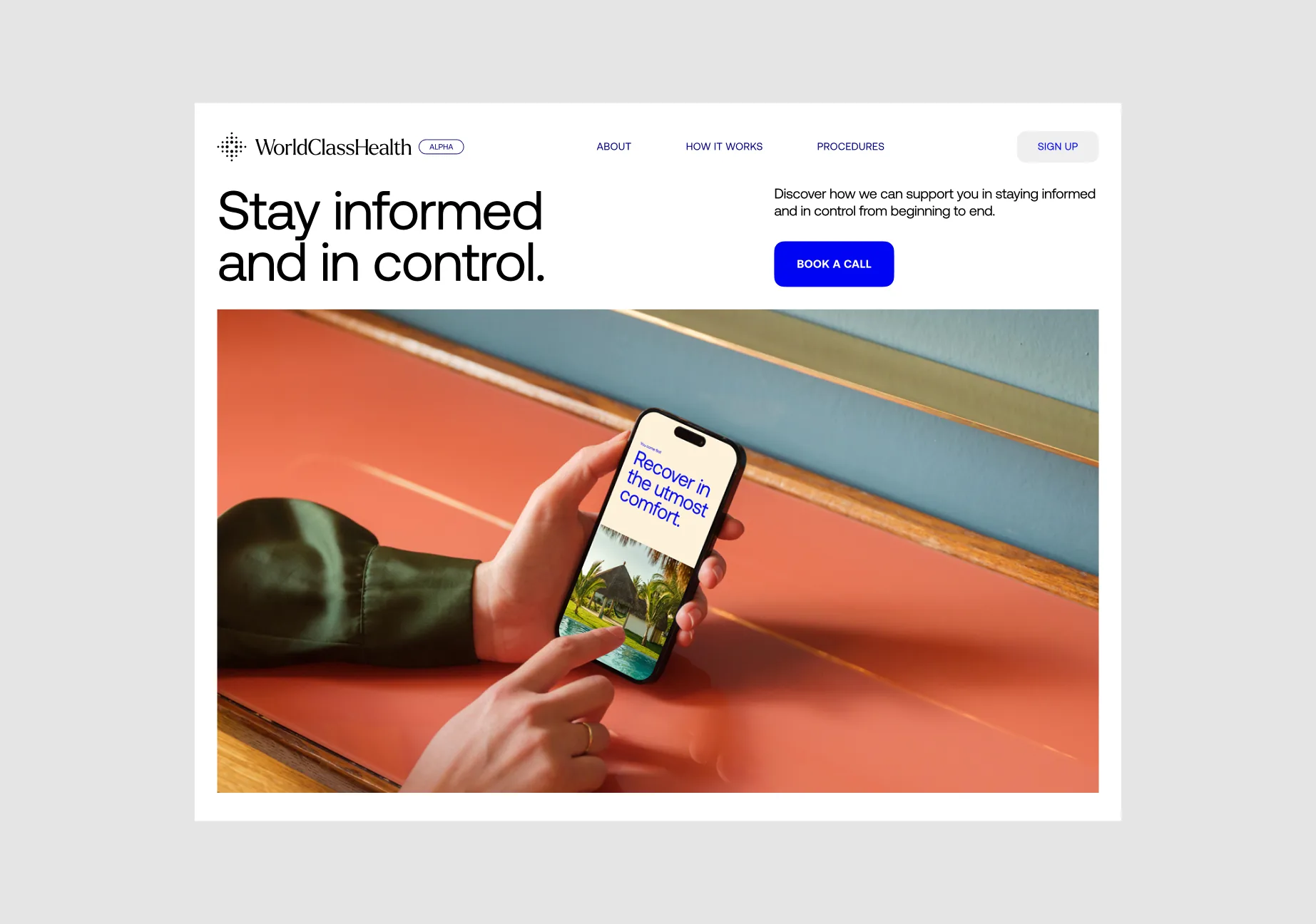 World Class Health website hero, 'Stay informed and in control,' with a hand holding a phone showing 'Recover in the utmost comfort'