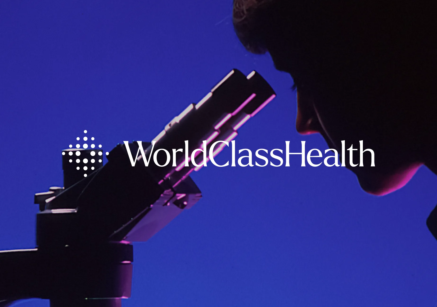 World Class Health logo over a blue-lit photo of a researcher looking into a microscope